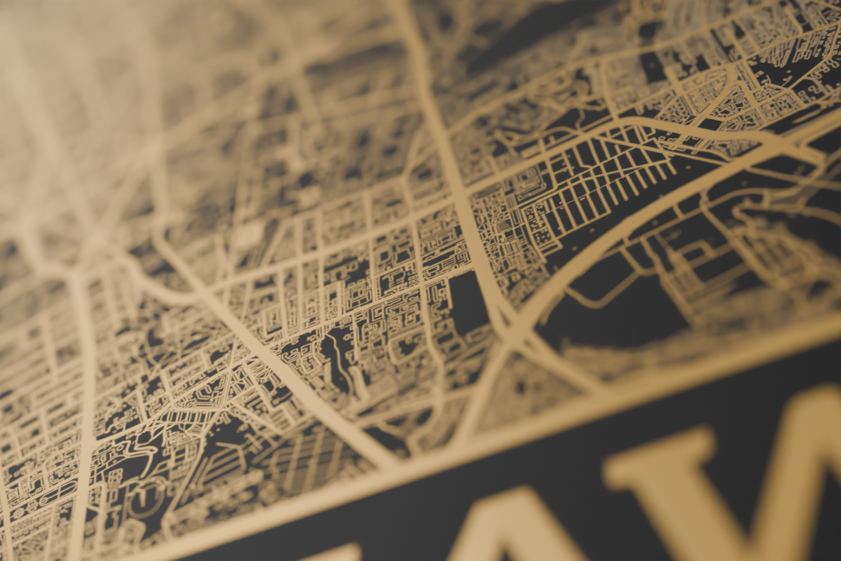 Close-up of black street detail on a reflective mirror-gold map